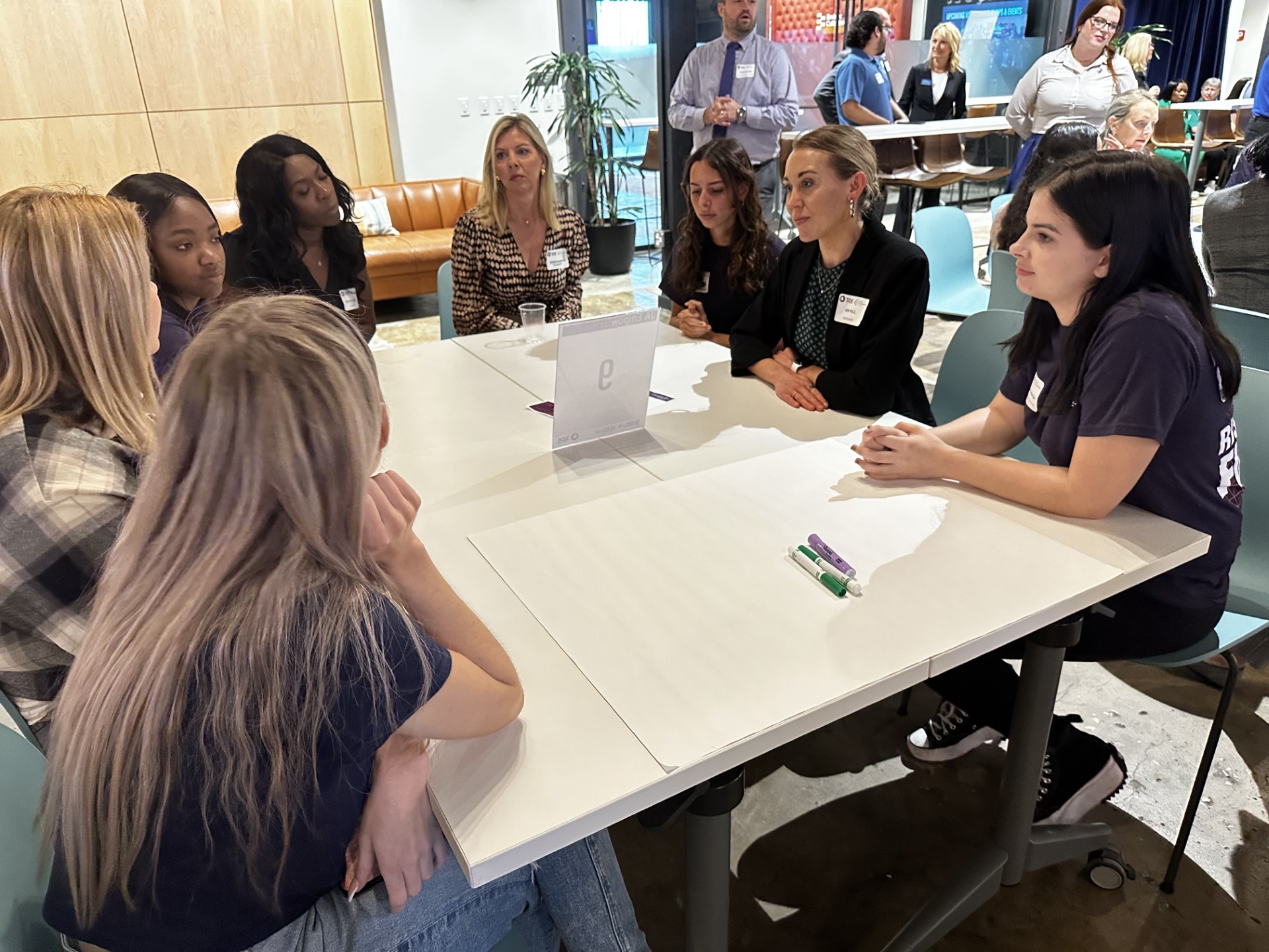 A group of women sitting around a tableDescription automatically generated